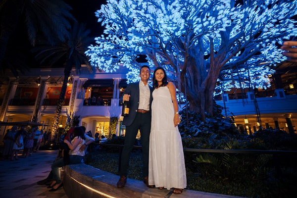 Couple in front of blue LED tree